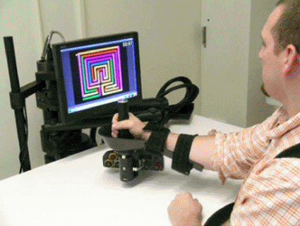 Image: A patient uses a robotic therapy device invented at MIT (photo courtesy U.S. Department of Veterans Affairs).